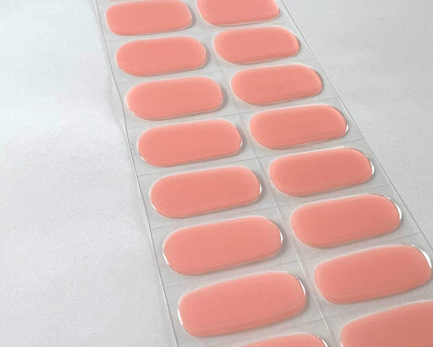 Strawberry Sunday pink semi-cured gel nails on angle zoomed in on white background