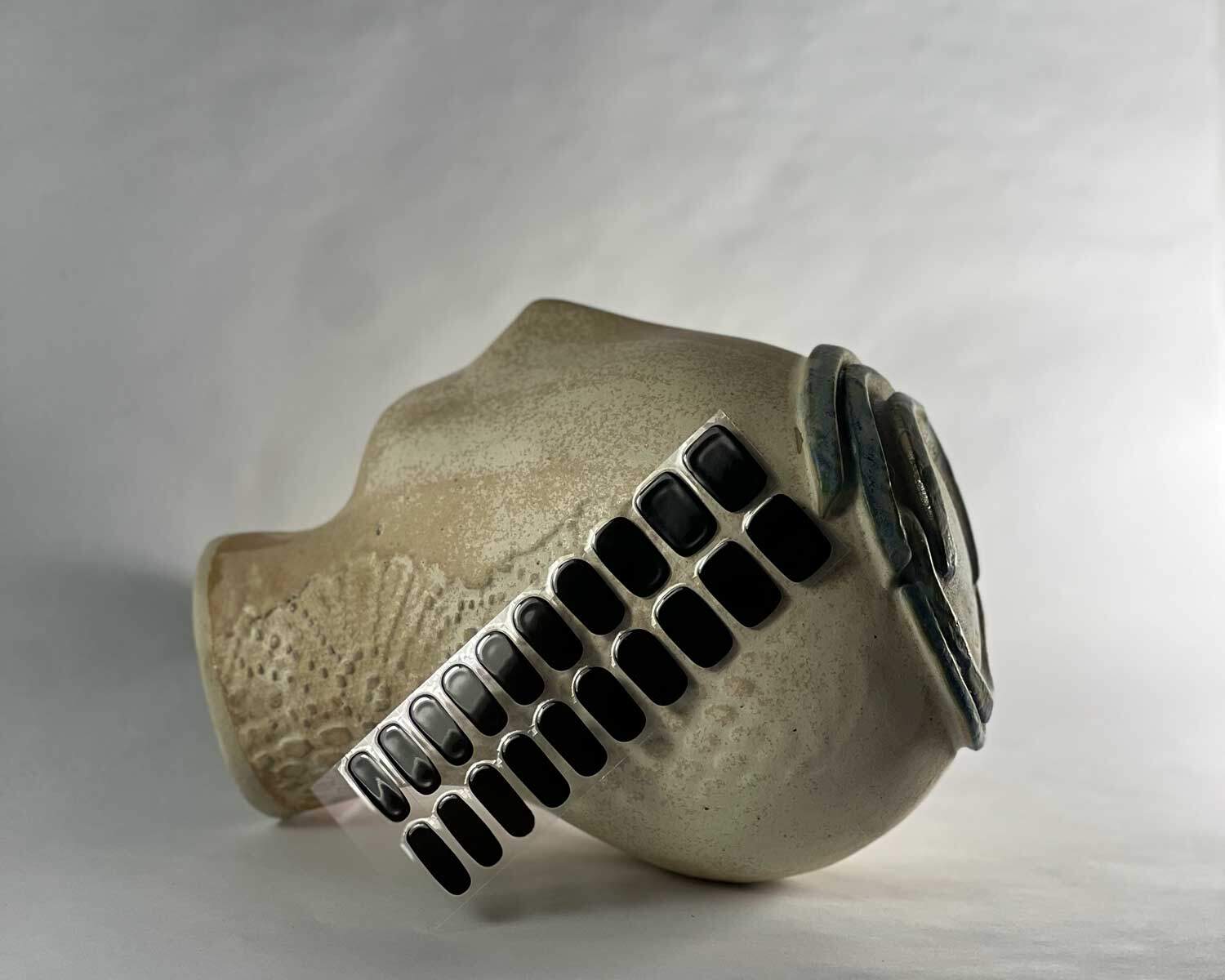 Night black semi-cured gel nails in mockup to show product against textured ceramic head with la-bek uv lamp in the background