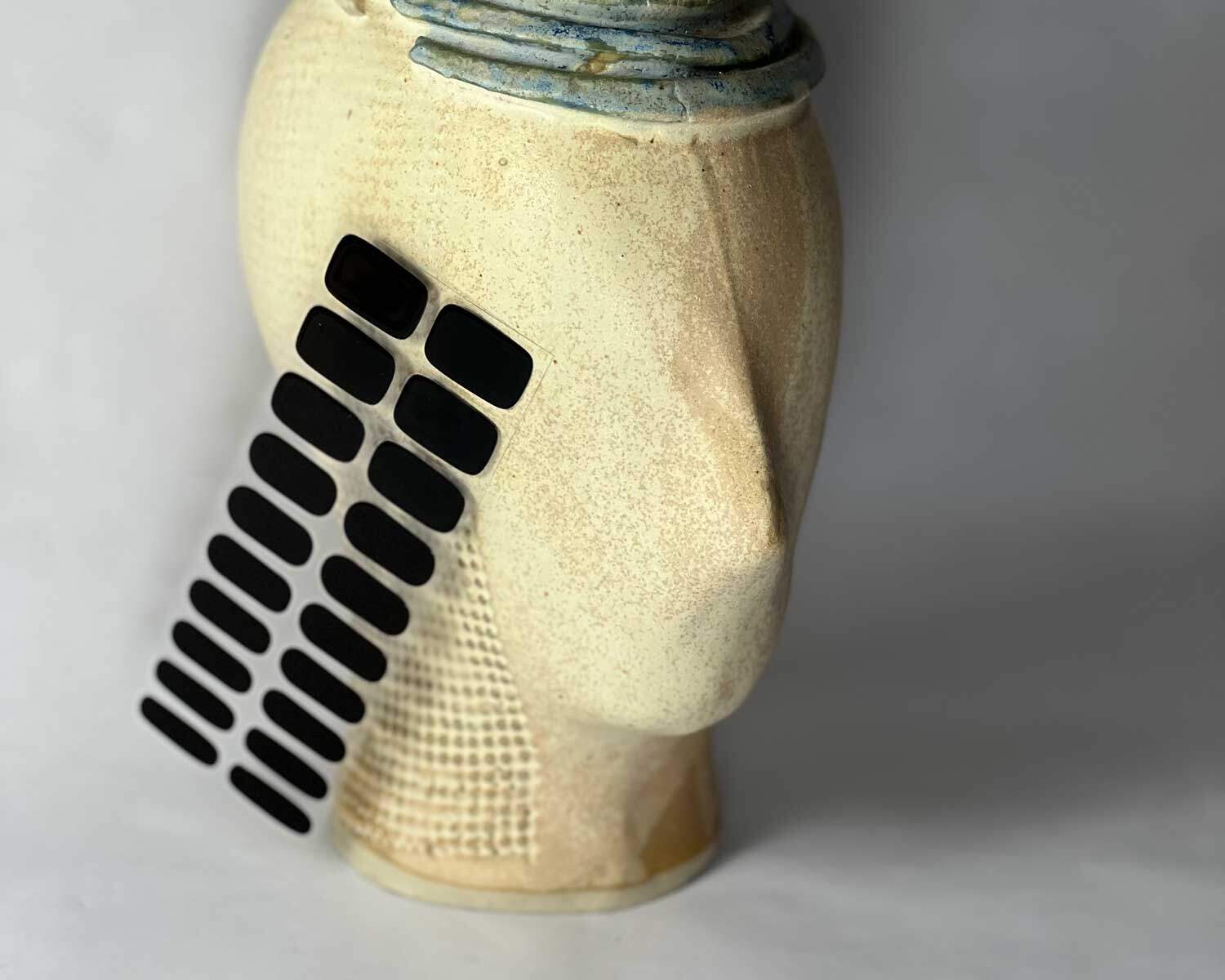 Night black semi-cured gel nails in mockup to show product against textured ceramic head with la-bek uv lamp in the background