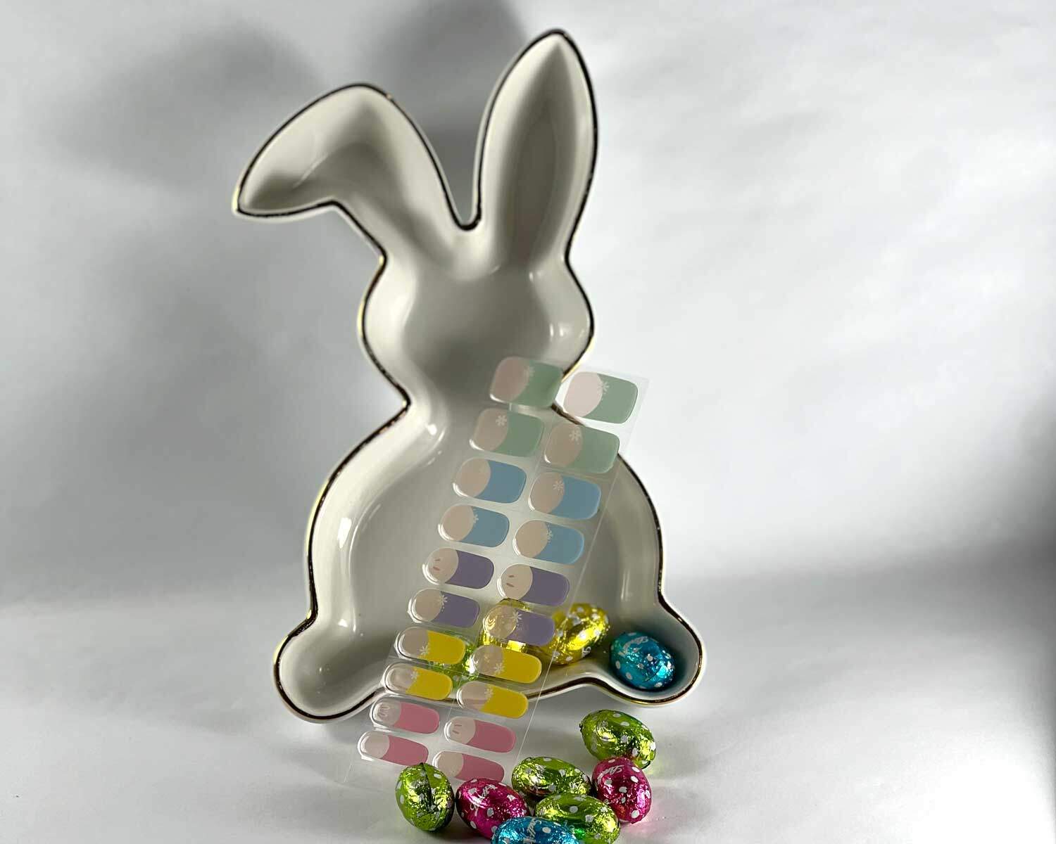 French bunny rainbow semi-cured gel nails in mockup to show product against bunny plate with easter eggs