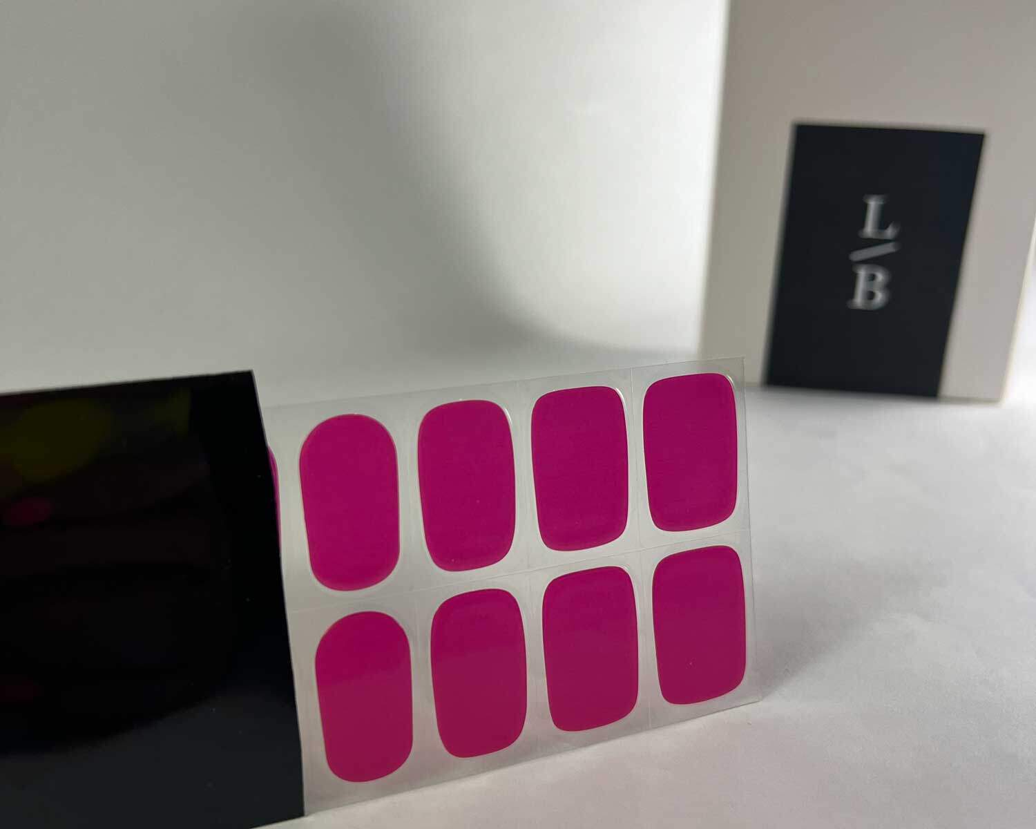 Lipstick love pink semi-cured gel nails in black light sensitive strip with la-bek uv lamp box in the background