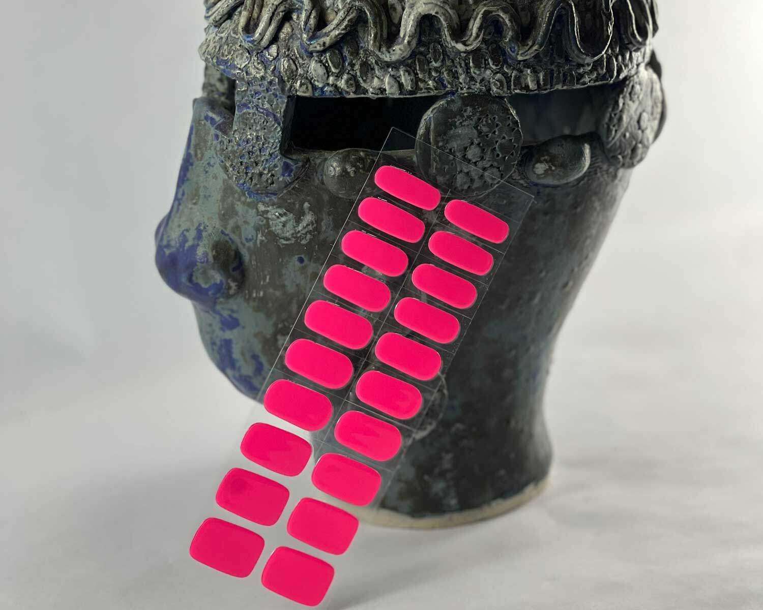 Barbie pink semi-cured gel nails in mockup to show product against textured ceramic