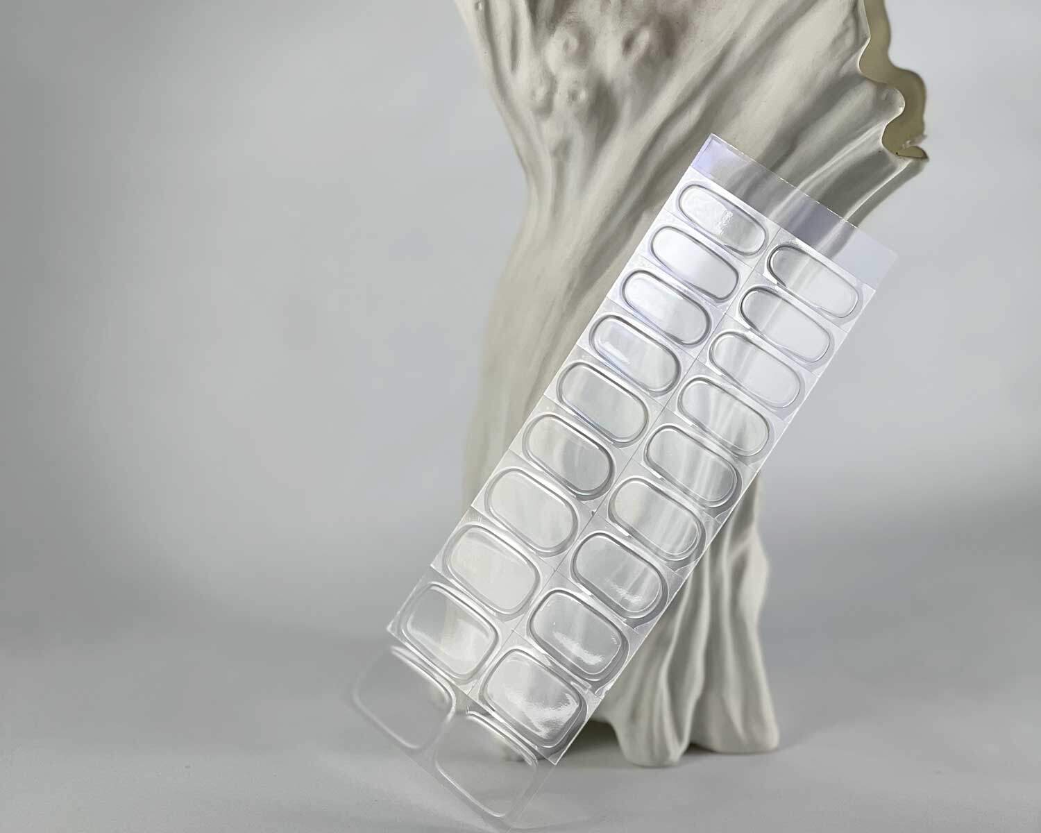 Transparent clear semi-cured gel nails in mockup to show product against white textured tree