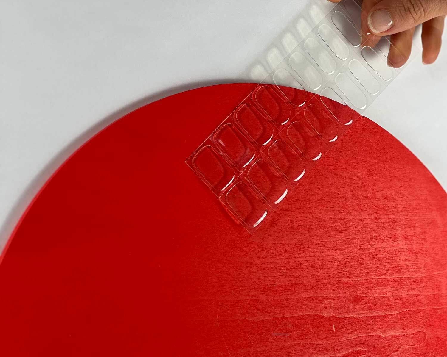 Transparent clear semi-cured gel nails in mockup to show product against red circle wooden block