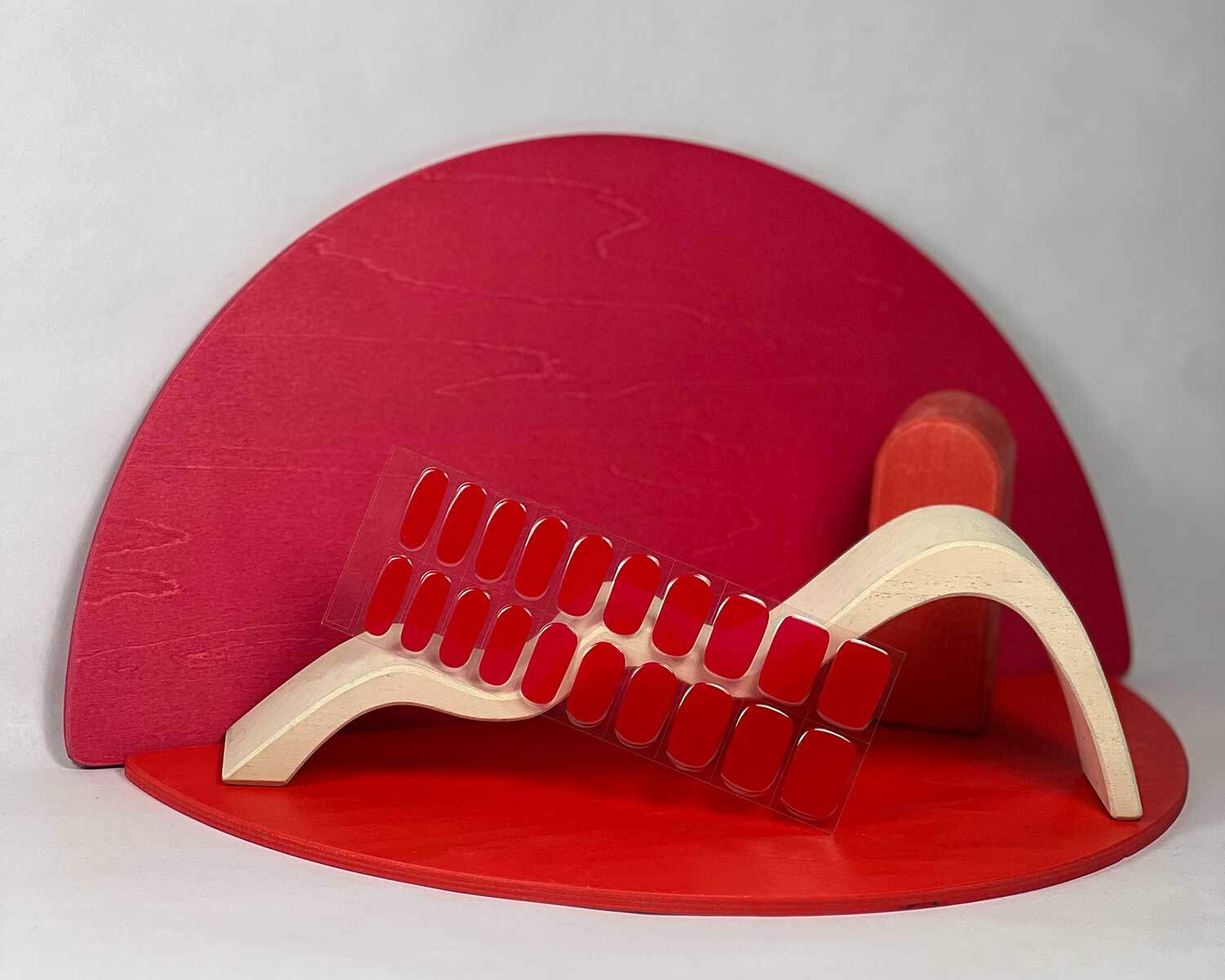 Cherry Red semi-cured gel nails in mockup to show product against red wooden blocks