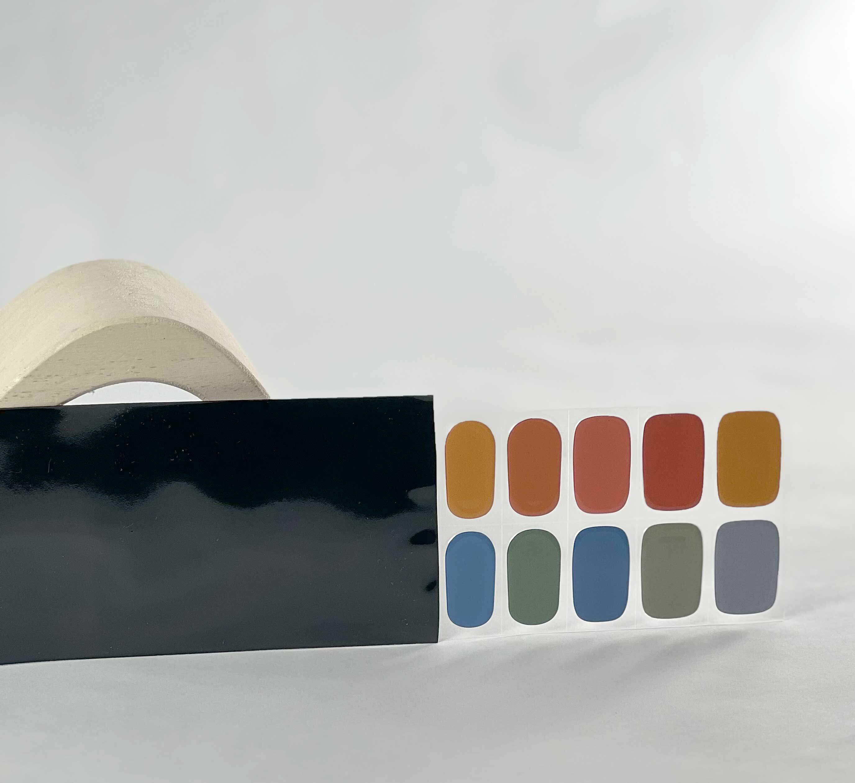 Rainbow dreams reds yellows blues semi-cured gel nails in black light sensitive strip with la-bek uv lamp box in the background