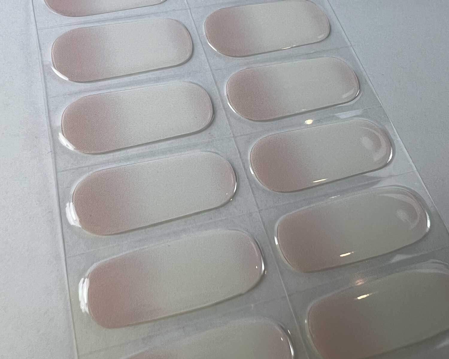 Pink Tide semi-cured gel nails on angle zoomed in on white background