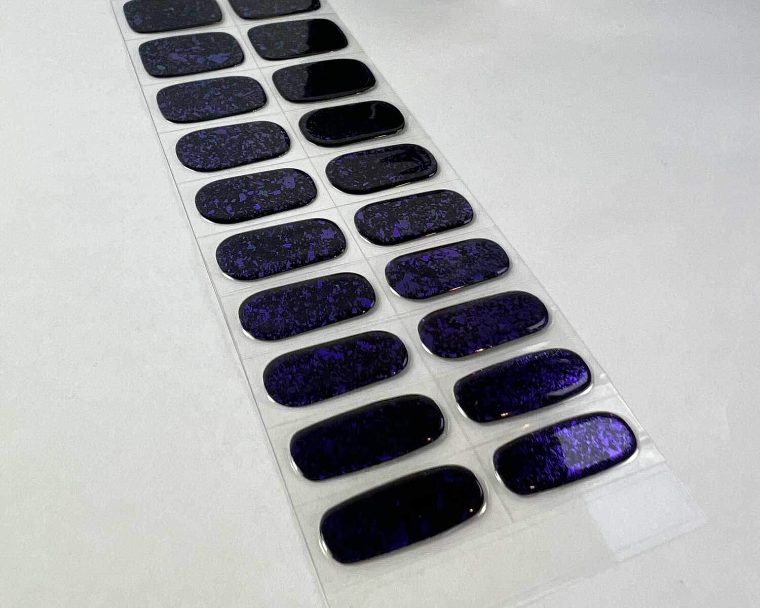 Violet Luster black and purple semi-cured gel nails on angle zoomed in on white background