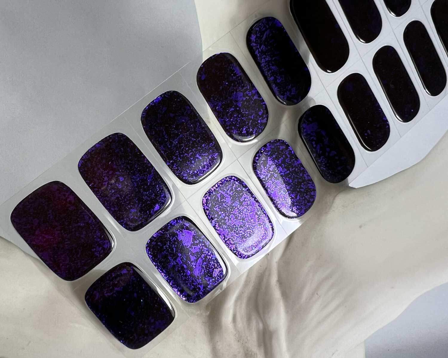 Violet Luster black and purple semi-cured gel nails in mockup to show product against white textured tree zoomed in.