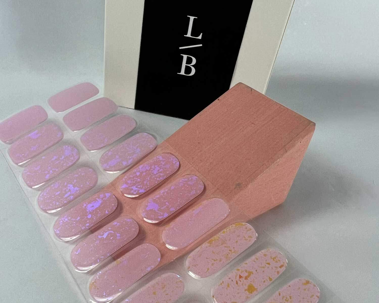 pink-speckle-semi-cured-gel-nail-angle Pink Speckle Orange semi-cured gel nails on angle zoomed in on white background with la-bek uv lamp box in the background