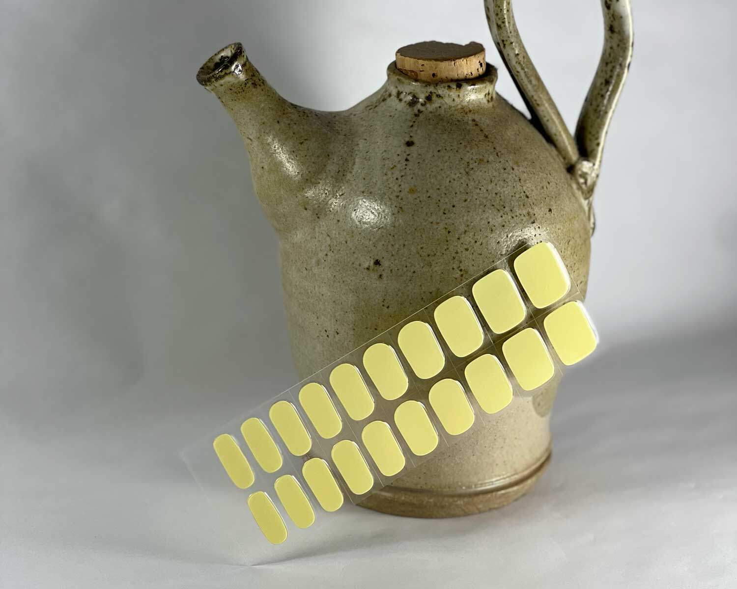 Lemonade yellow semi-cured gel nails in mockup to show product against ceramic vase