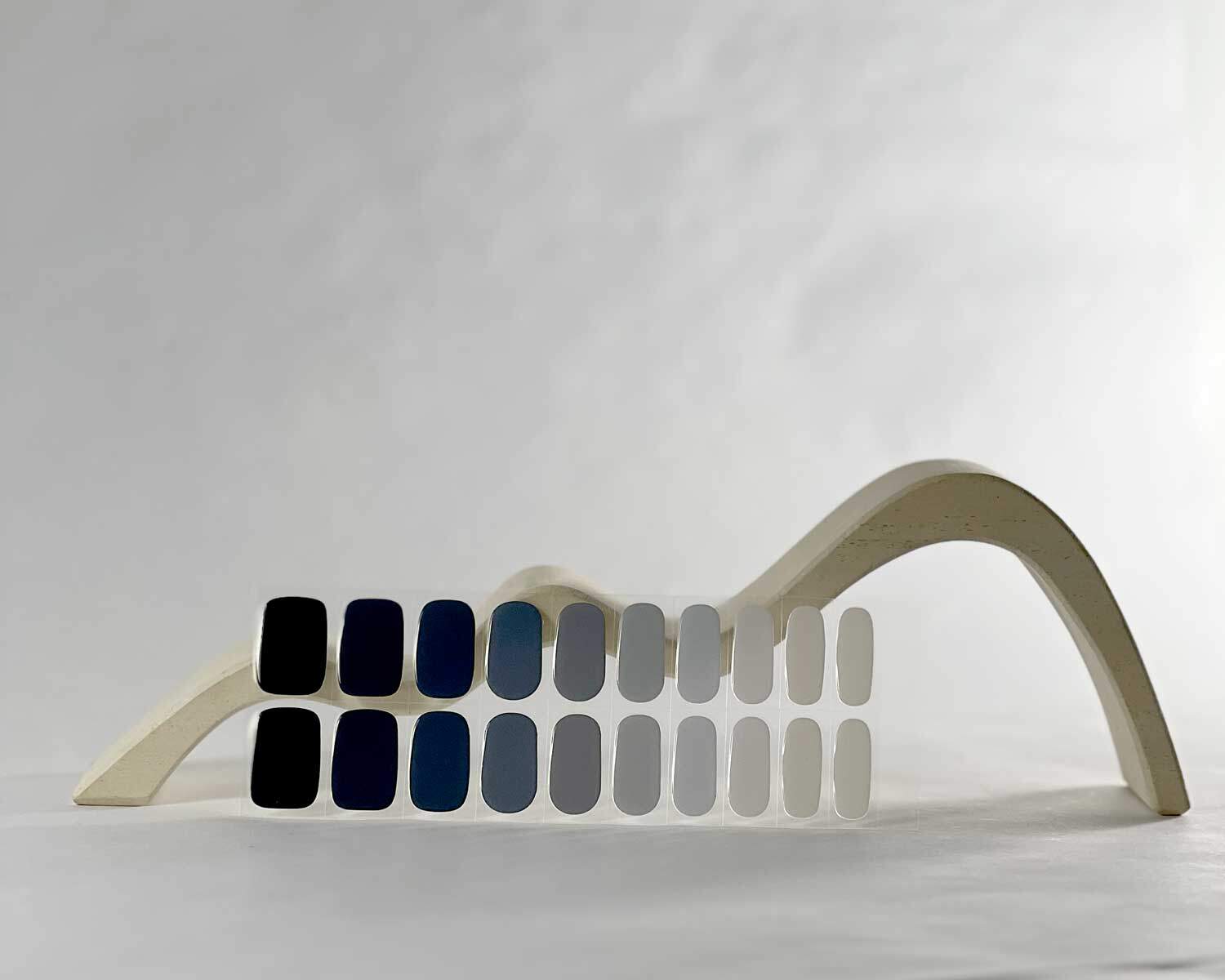 Blueberry Bush Blue semi-cured gel nails in mockup to show product against white wave wooden block