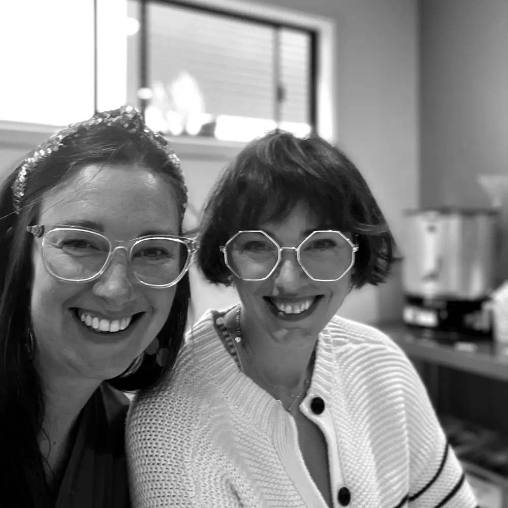uv lamp on showing light and red semi-cured gel nails on red wooden backdrop