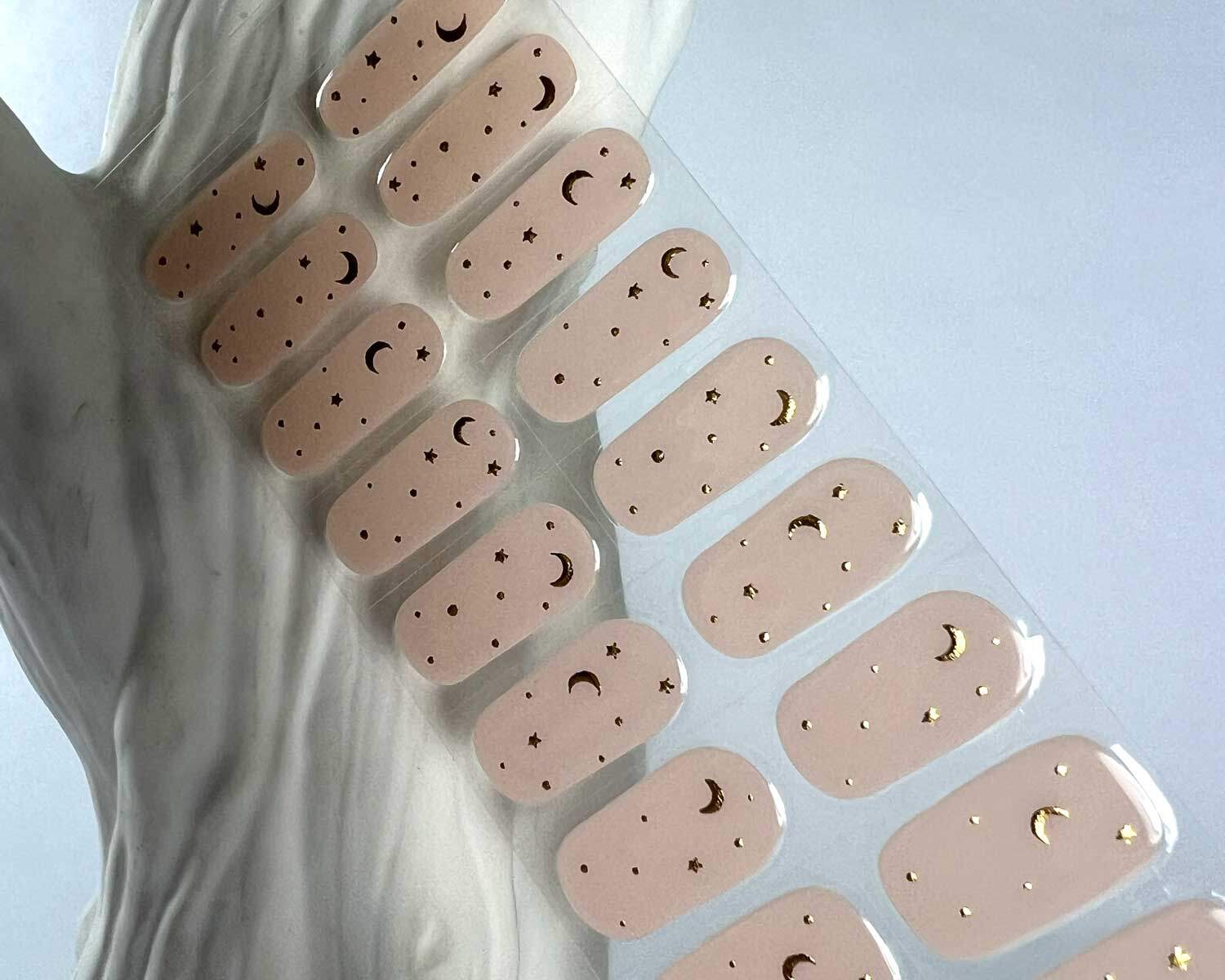 moon child semi cured gel nails in mockup to show product against white tree on white background zoomed in