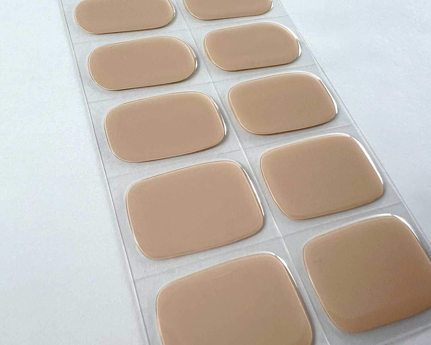 oat latte brown semi-cured gel nails on angle zoomed in on white background