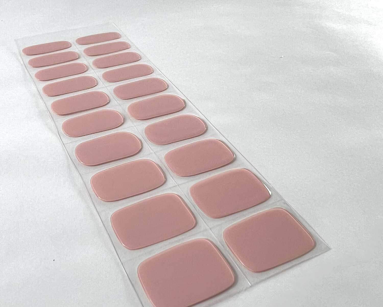 pink marshmallow semi-cured gel nails on angle zoomed in on white background