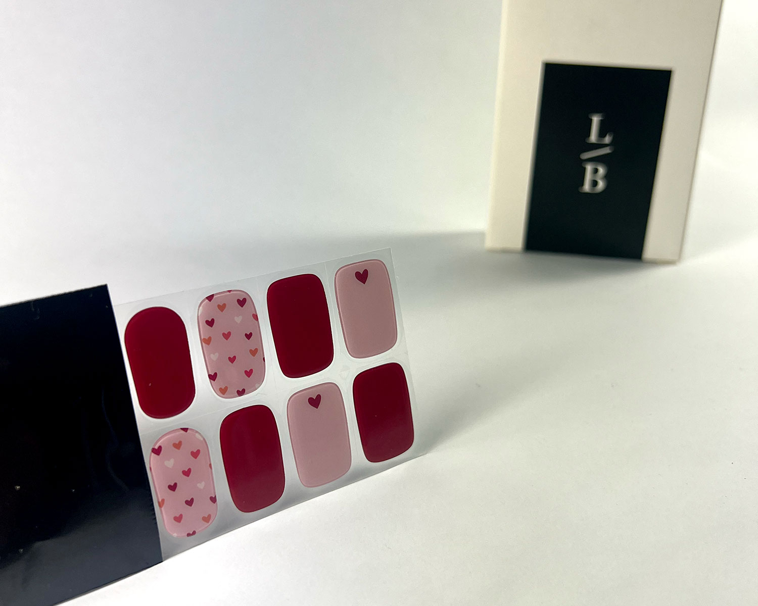 queen-of-hearts-semi-cured-gel-nail-black-strip-angle